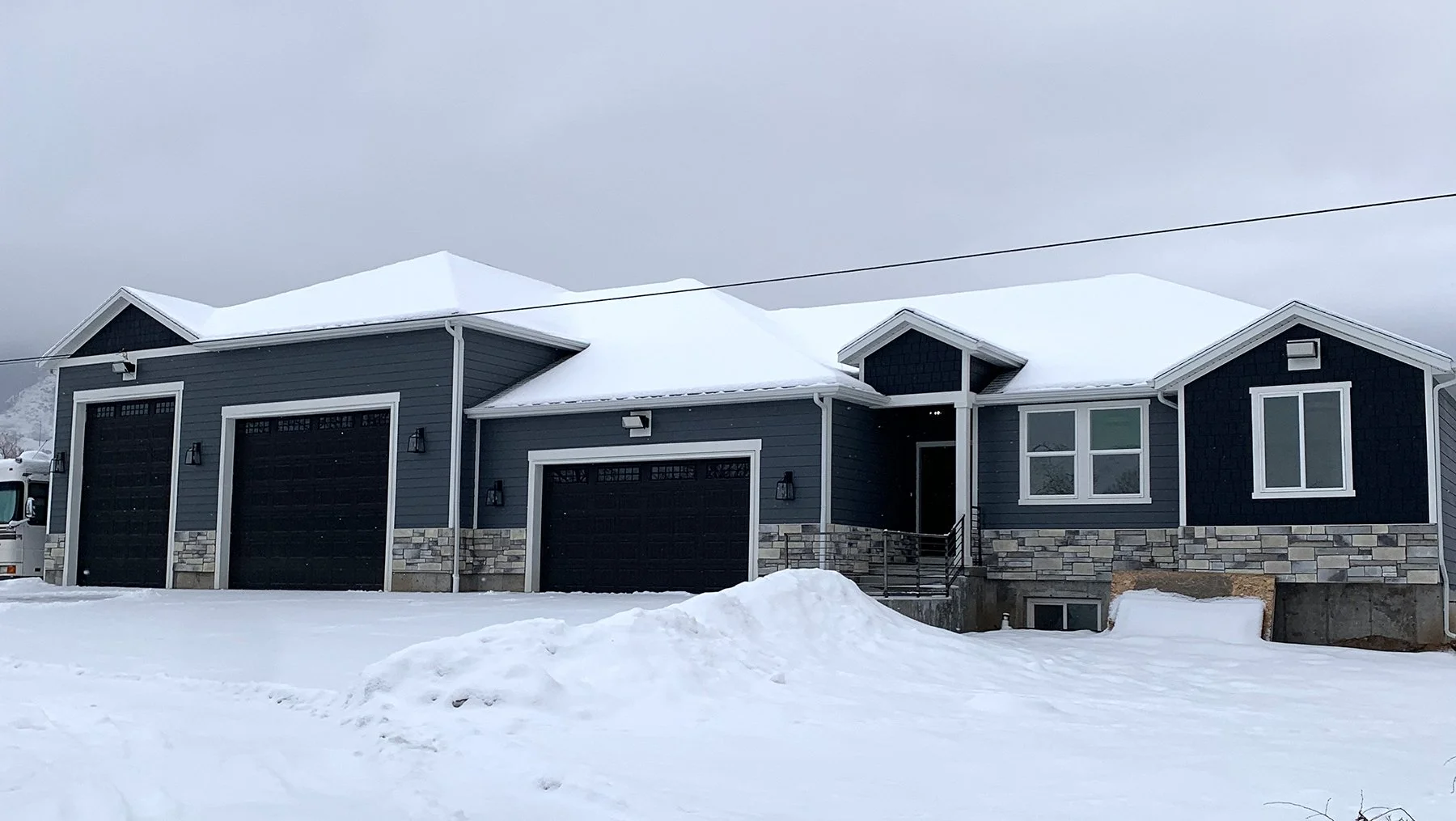 Custom Blue-Siding Rambler with 3-Car Garage