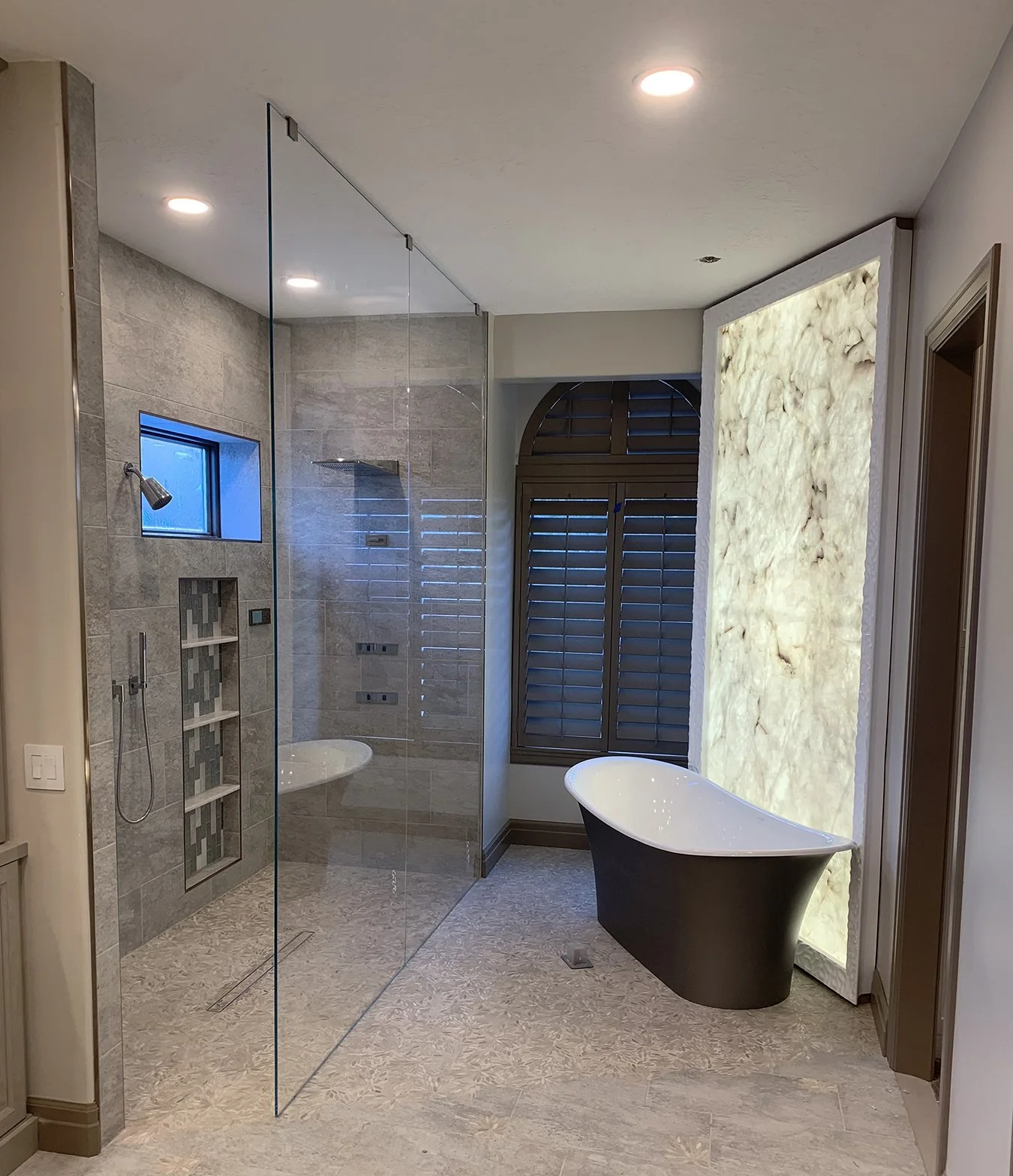 Backlit Onyx Master Bath with Freestanding Tub