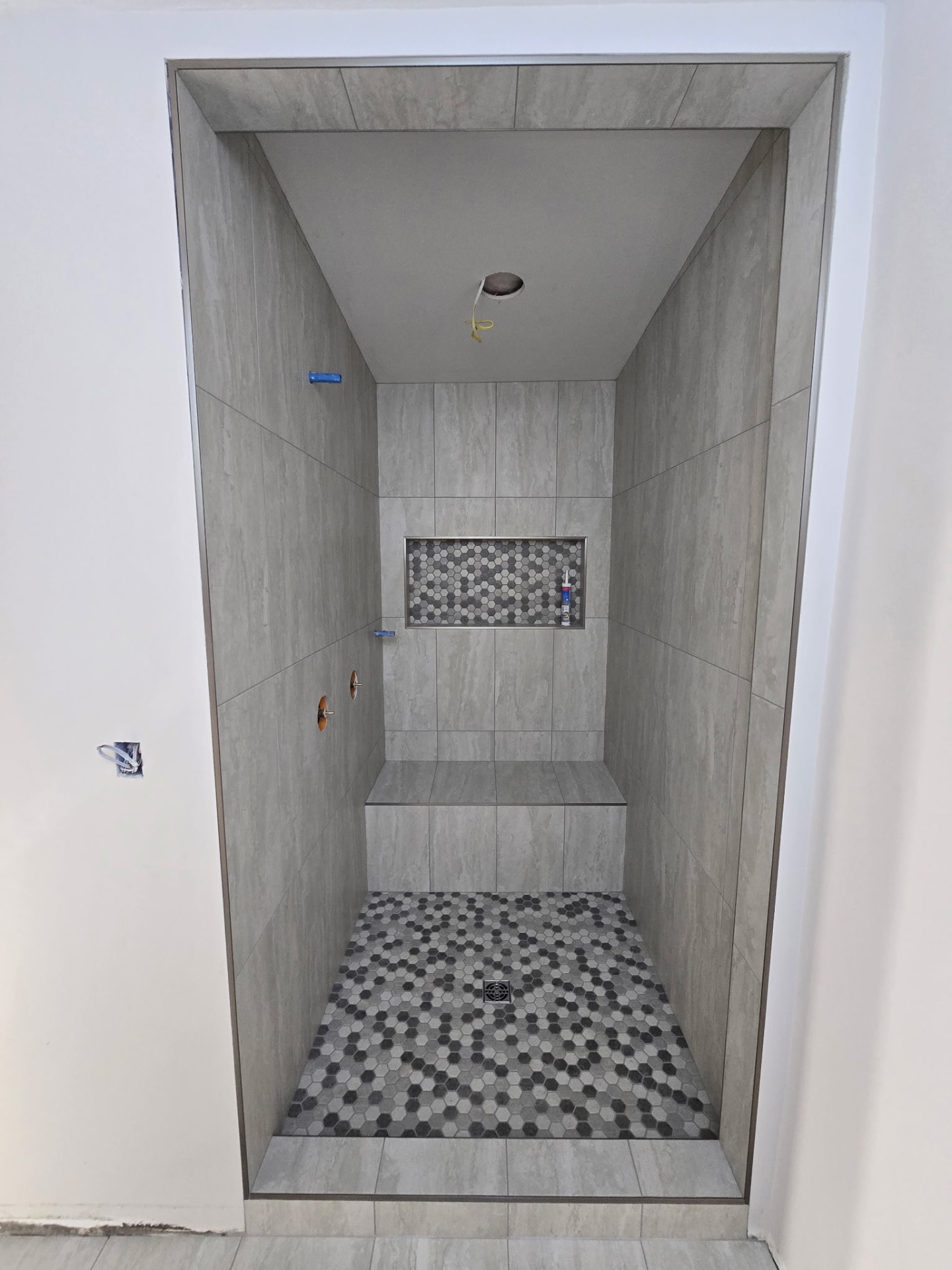 Gray Stone-Look Walk-In Shower with Hex Mosaic
